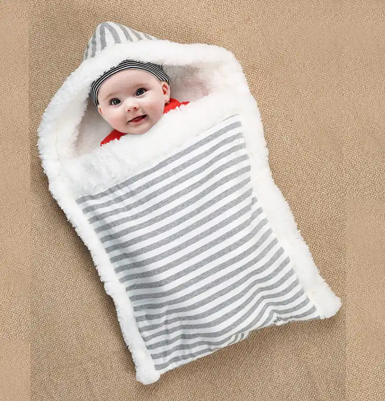 Blue stroller wrap sleeping bag in envelope shape, open and ready to use