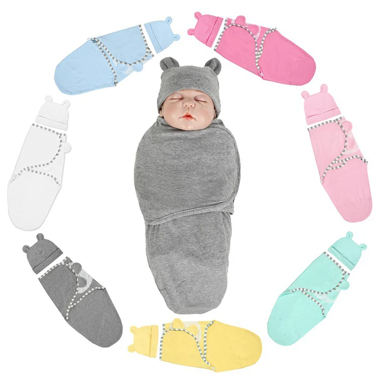 Pink cotton stretchy baby swaddle blanket with hat, laid flat