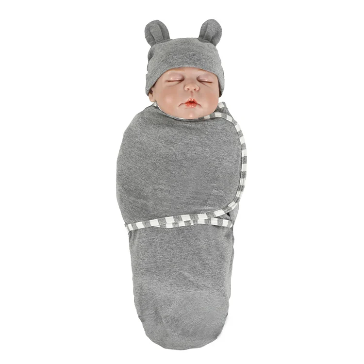Grey cotton stretchy baby swaddle blanket with hat, open and ready to wrap