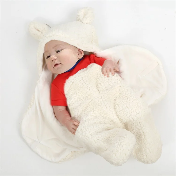 Fleece infant bear hooded sleeping bag in cream, close-up of soft plush fabric