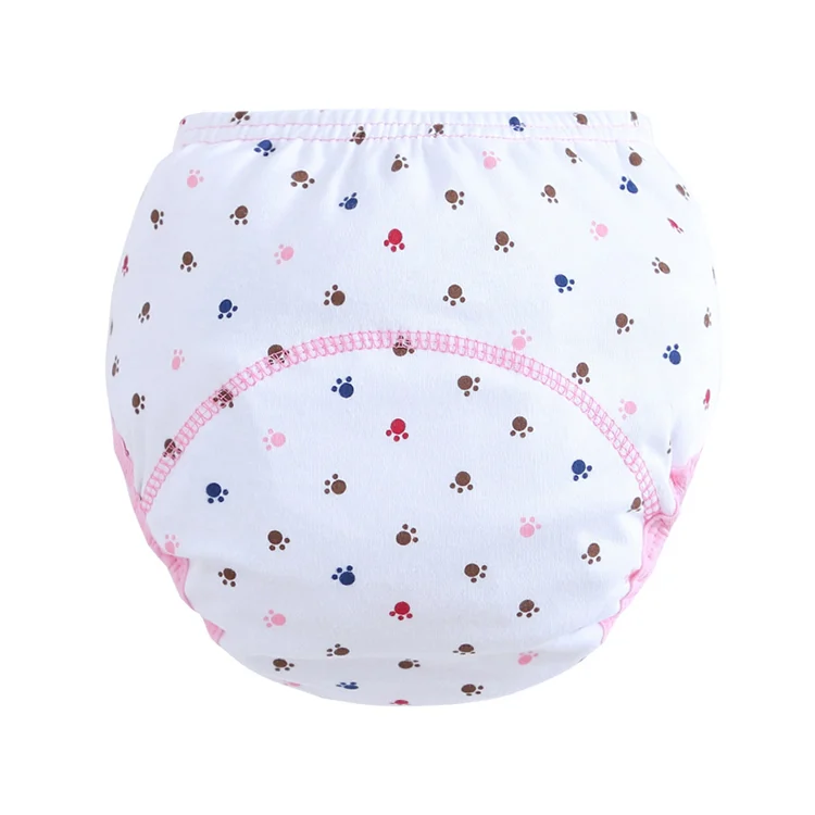 Pink floral reusable cloth diaper laid flat, showing cotton inner and TPU outer