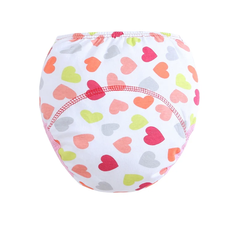 Multiple reusable cloth diapers in different patterns laid out in a row