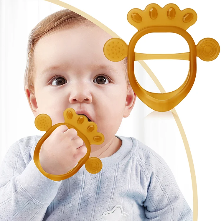Transparent silicone baby teether with multi-texture surface, held in hand