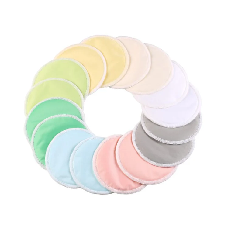 Two reusable bamboo nursing pads laid flat in an OPP bag