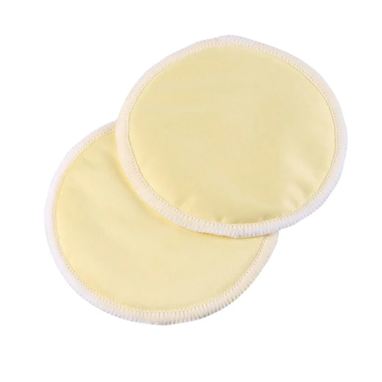 Side view of a bamboo nursing pad showing multi-layer construction