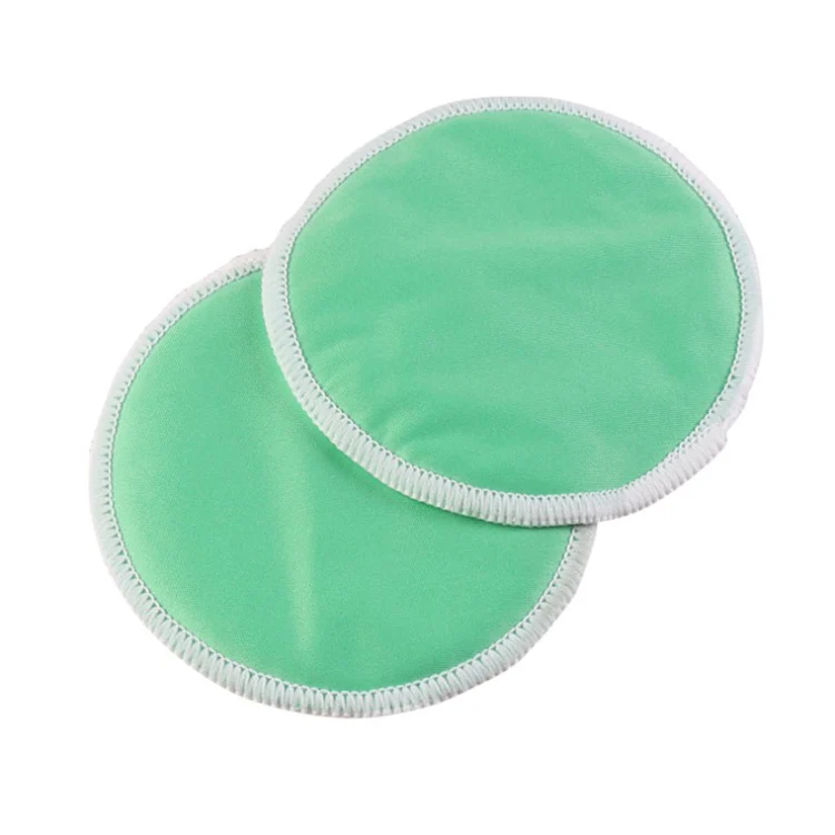Nursing pad folded in half to show thickness and edge stitching