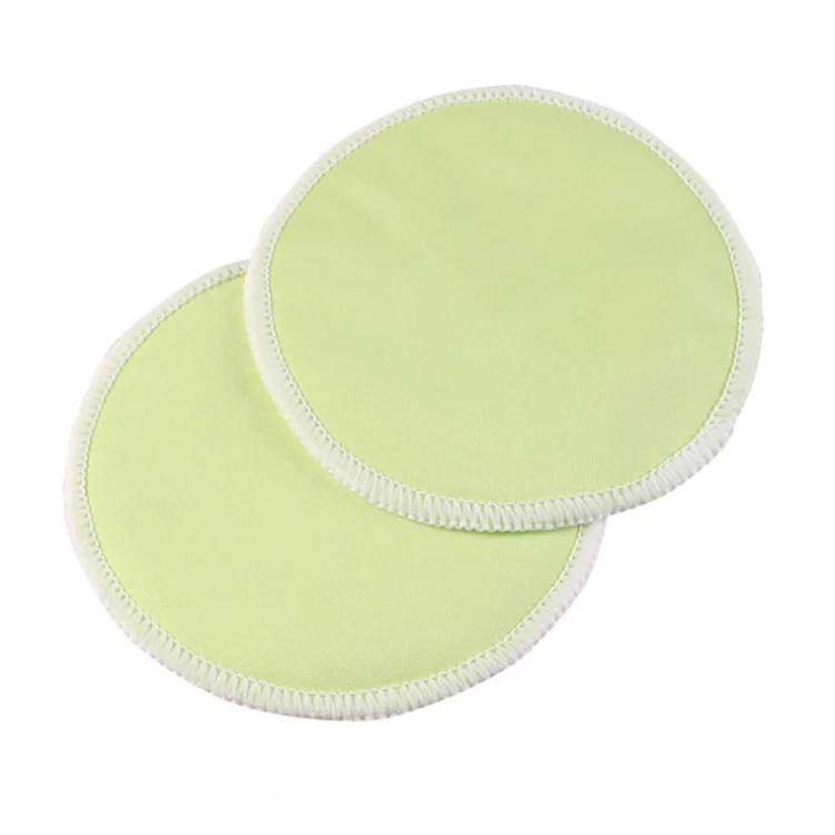 Nursing pad with a drop of liquid on the surface, demonstrating leak resistance