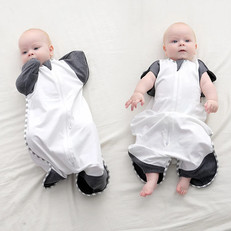 Baby sleep bag worn by a newborn with arms and legs free