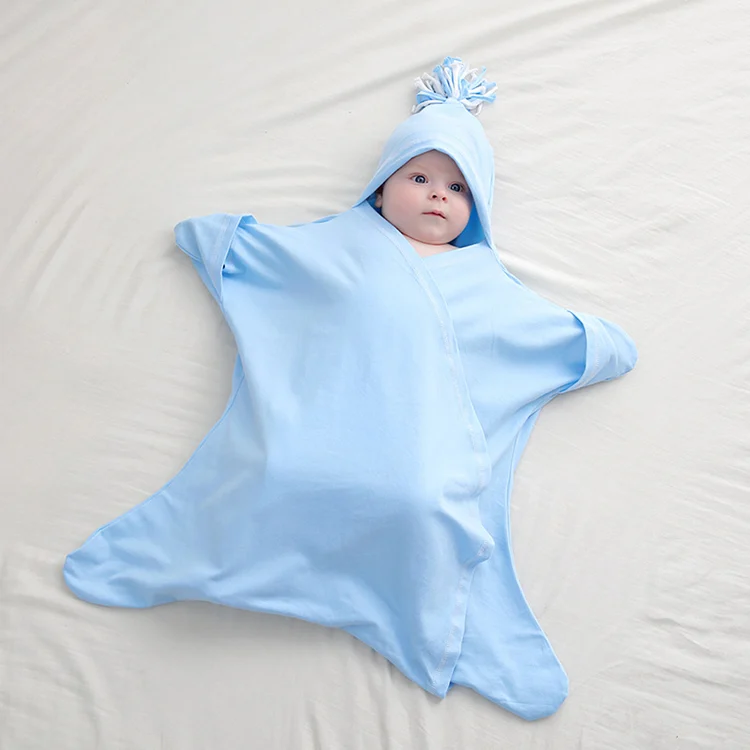 Pink star-shaped baby sleep bag laid flat, showing the open chest and starfish shape