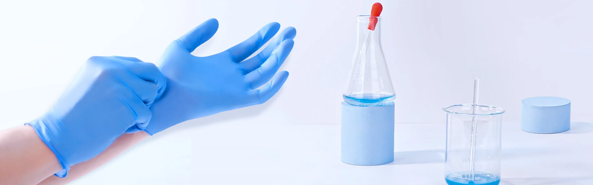 Nitrile gloves alongside laboratory glassware