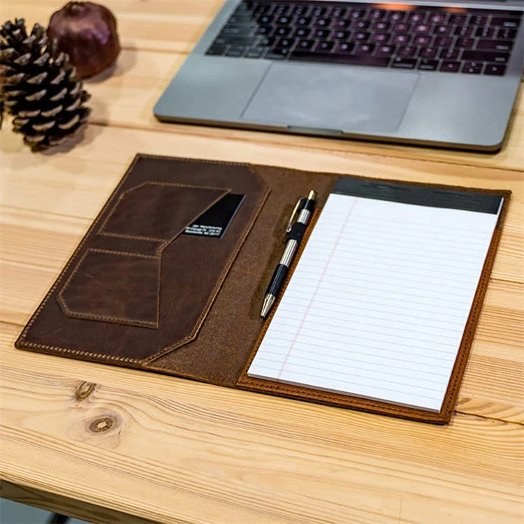 Notebook holder shown on a desk with a pen