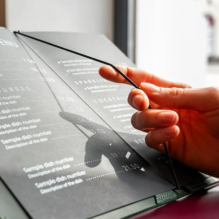 Server holding the open leather menu in a dining room