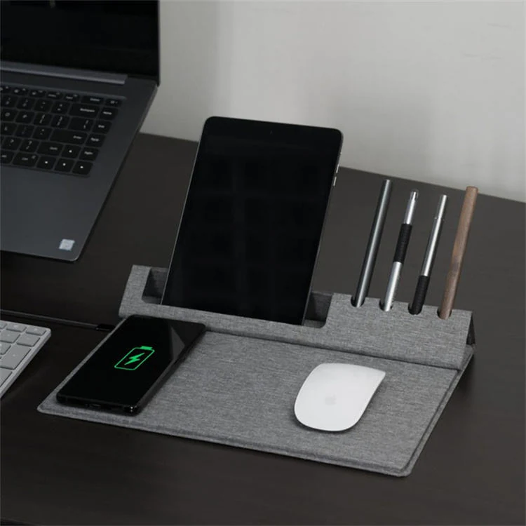 Wireless charging office mouse pad in use on a desk with a laptop
