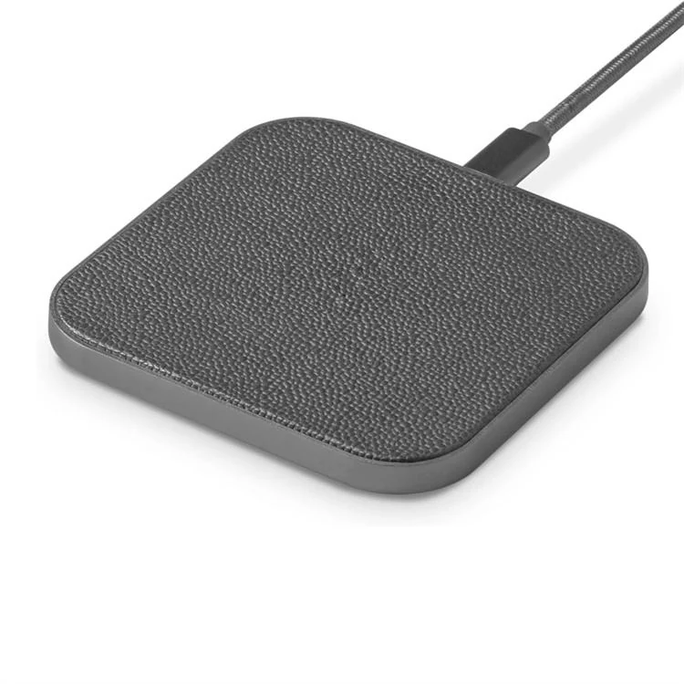 Charger shown with a smartphone charging on the pad
