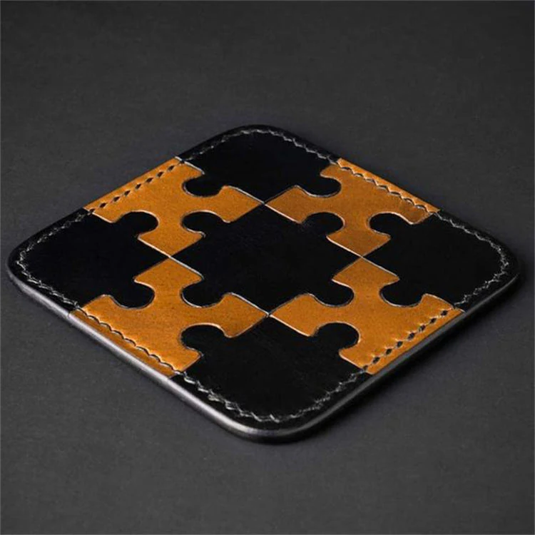 Leather coasters arranged on a dark wooden surface