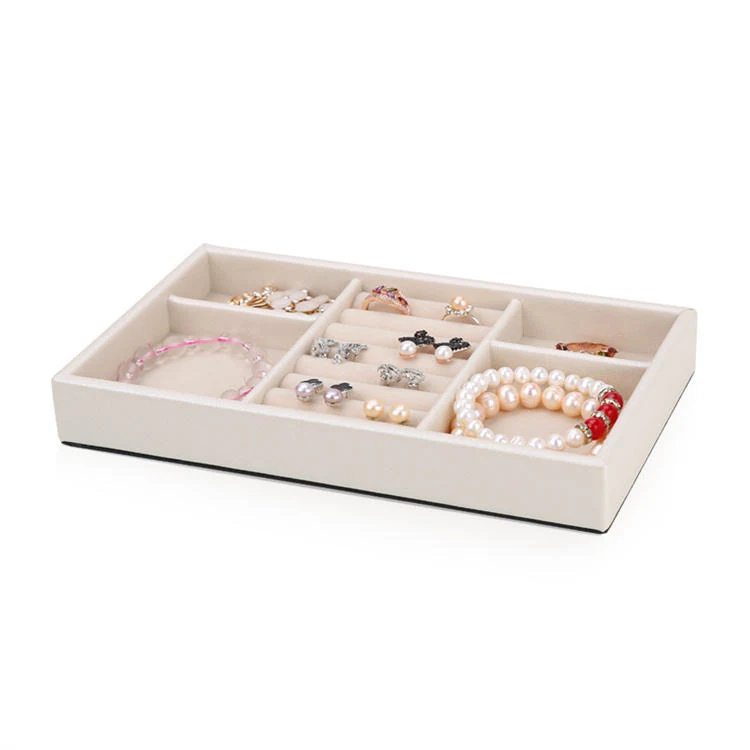 Tray holding rings and earrings in separate wells