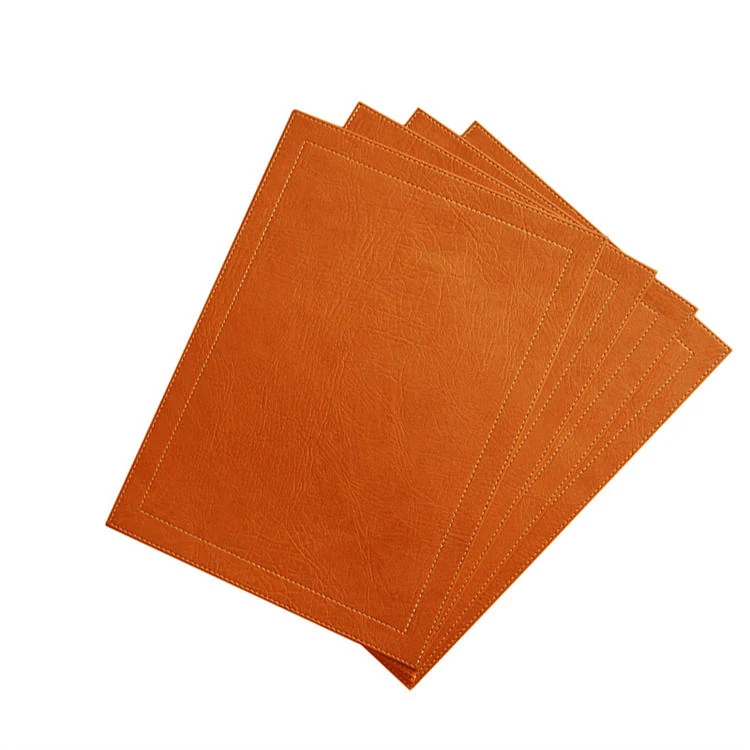 Red leather placemat with matching coaster on a dining table
