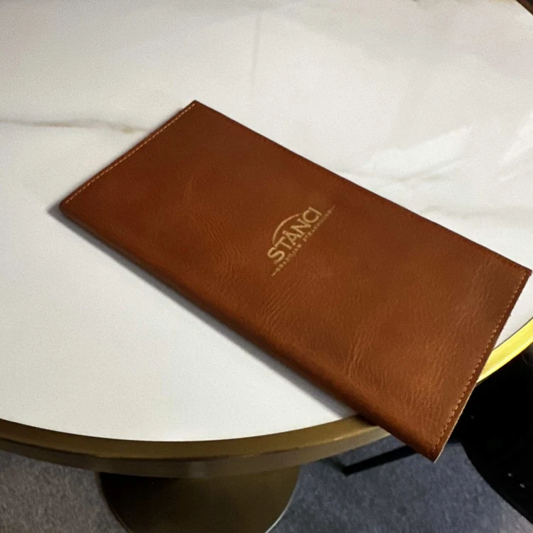 Service book held by a server in a dining room
