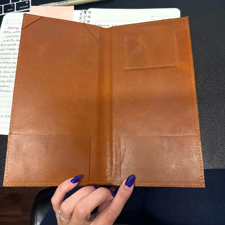 Service notebook open showing the inner bill pocket