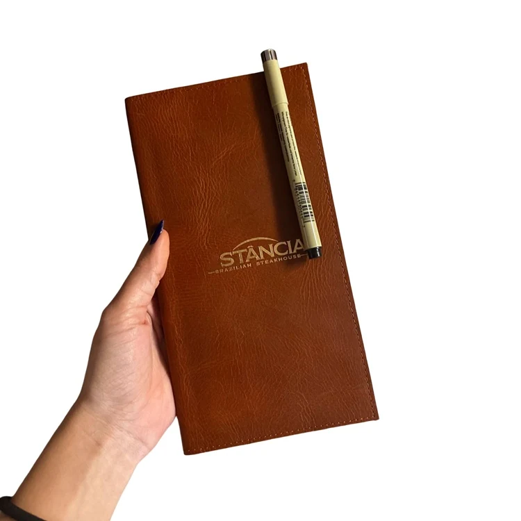 Brown full-grain leather restaurant service notebook with embossed logo