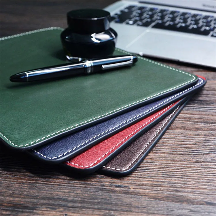 Stacked leather mouse pads showing multiple colours