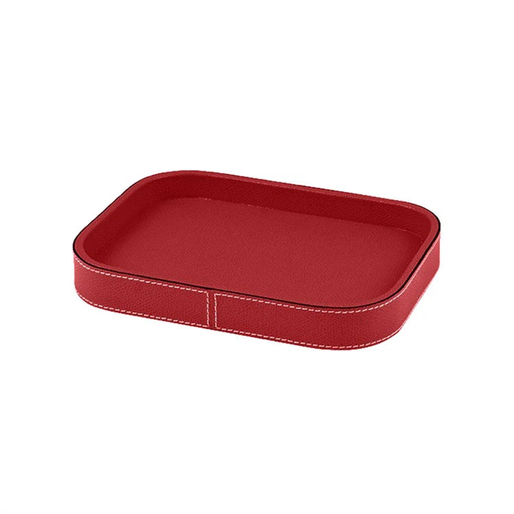 Dark grey leather tray holding keys and stationery