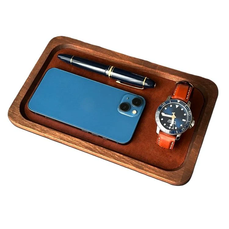Tray holding pens and a phone on a desk