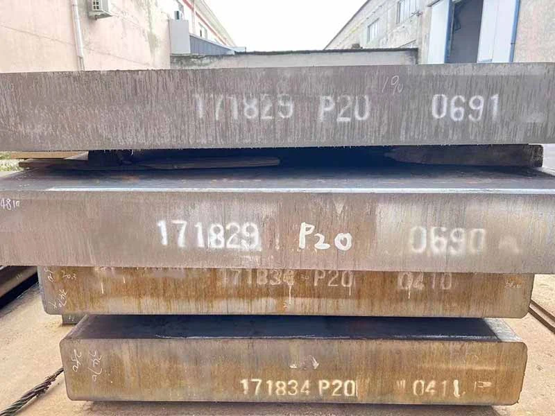 Stacked steel blocks stenciled with batch numbers on their ends