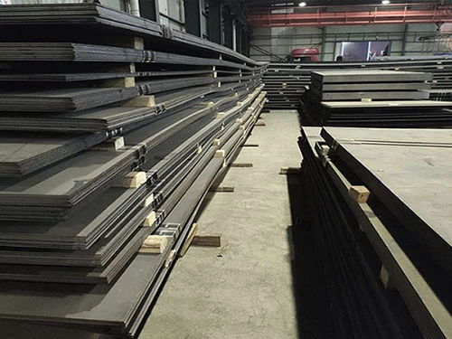 rows of steel plates stacked inside a large storage warehouse