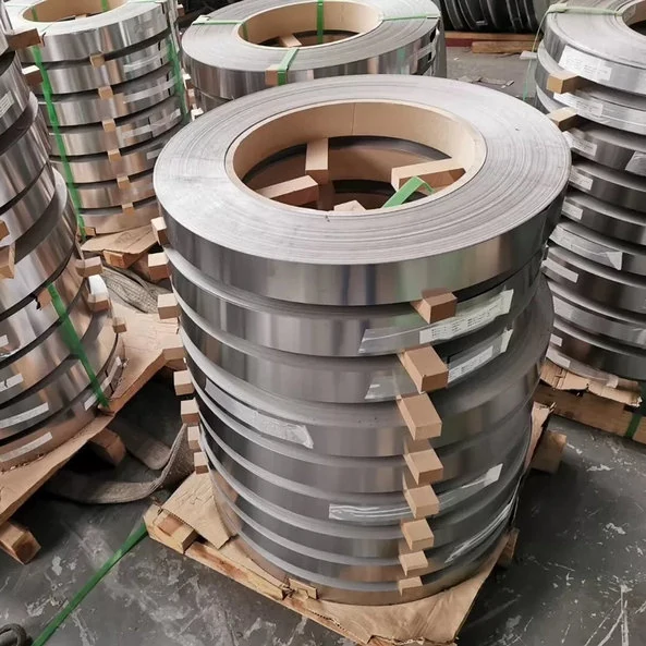 Slit steel strip coils standing on wooden pallets in a warehouse
