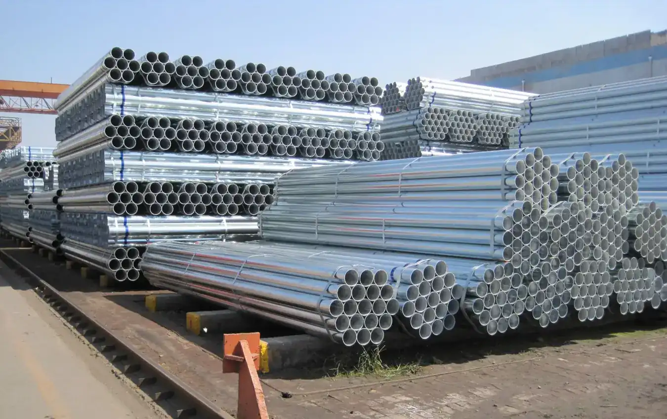 Galvanized steel pipe bundles stacked outdoors in a storage yard