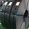 strapped slit steel coils with tags standing on a mill floor