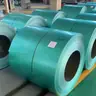 Rows of green pre-painted steel coils stored indoors