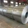 Large galvanized steel coil standing on a warehouse floor