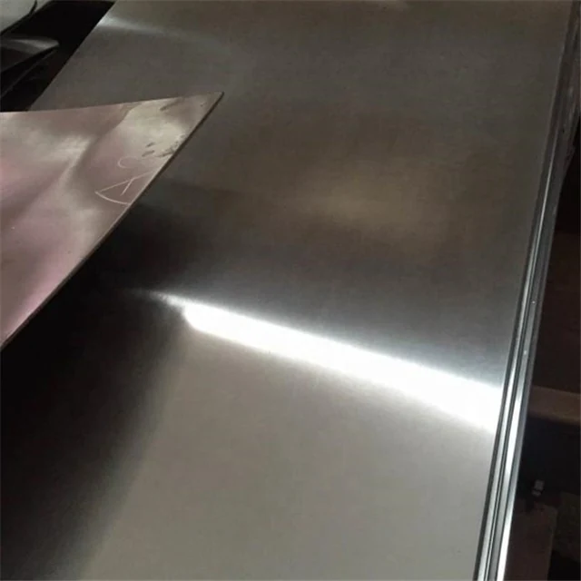 Close-up of a brushed stainless steel sheet catching the light