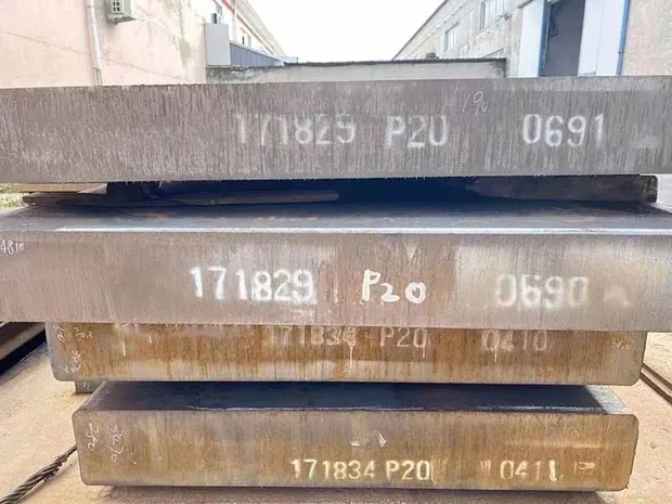 Stacked steel blocks stenciled with batch numbers on their ends