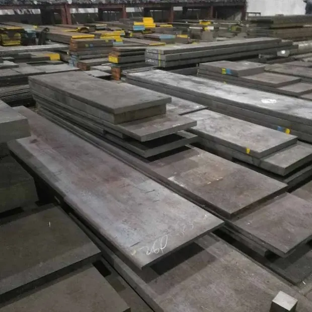 Cut steel plates stacked in rows inside a workshop