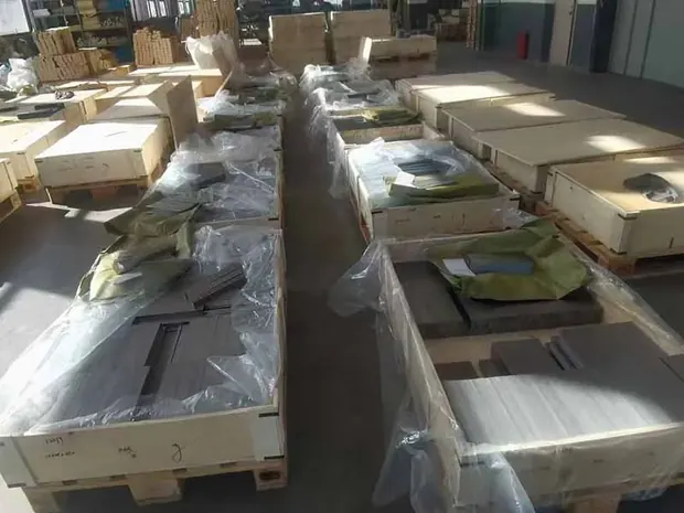 Long steel sections wrapped and loaded into wooden crates