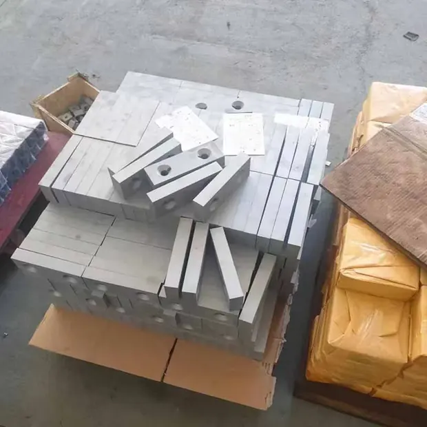 Machined steel blocks and flat bars laid out on a pallet