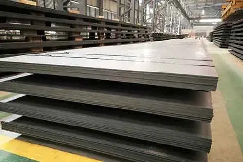 Stacked steel plates in a warehouse aisle beside yellow floor line