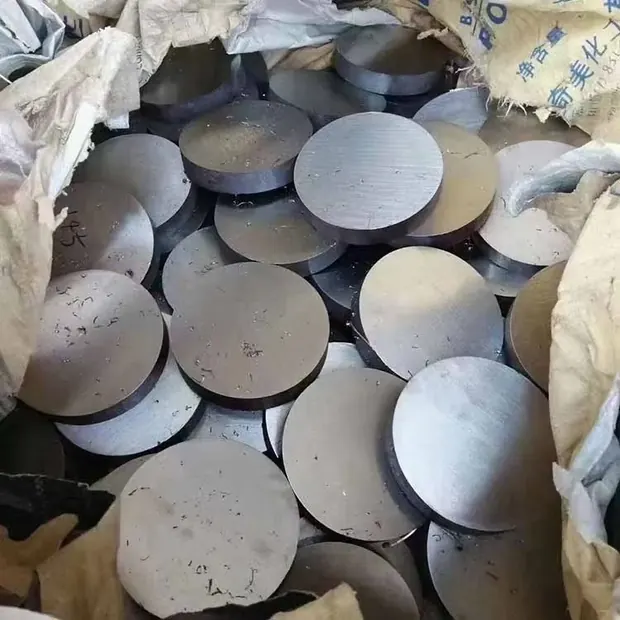 pile of round steel discs with bright sawn faces in paper wrap