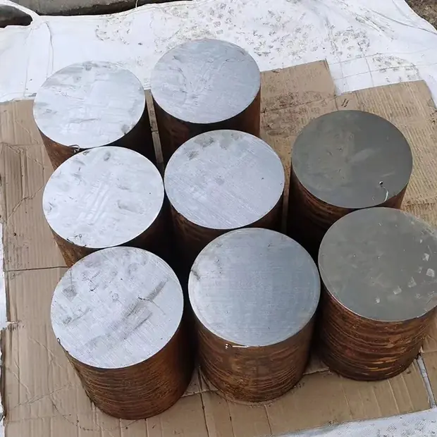 round steel billets standing upright on a pallet, machined bright ends