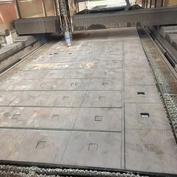 Cutting table with parts burned out of a large steel plate