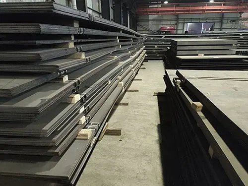 rows of steel plates stacked inside a large storage warehouse