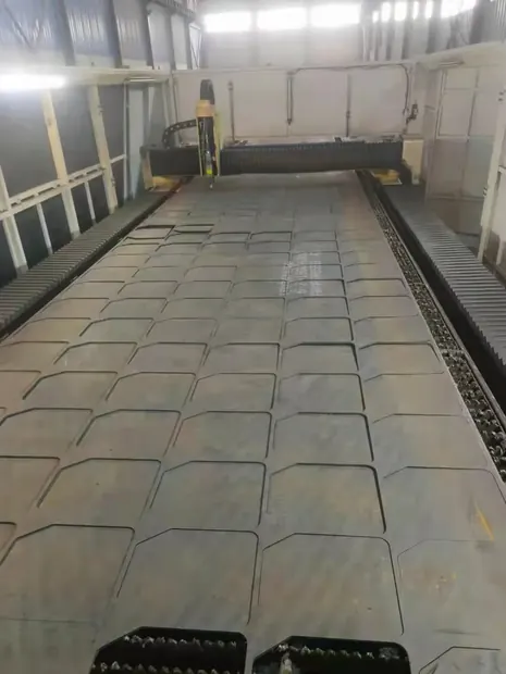 steel plate on a cutting table with square blanks cut out