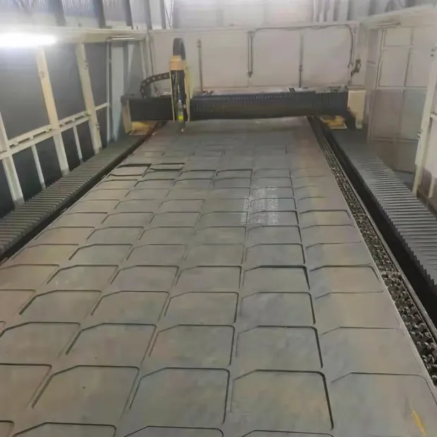 Cutting bed covered with nested plate parts under a gantry machine