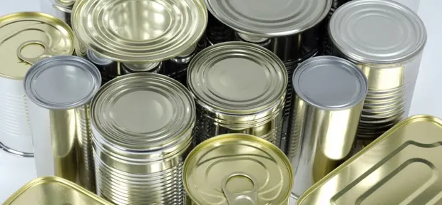 Empty tinplate cans with gold and silver lacquered surfaces