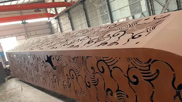 rust colored weathering steel panel with laser cut scroll pattern