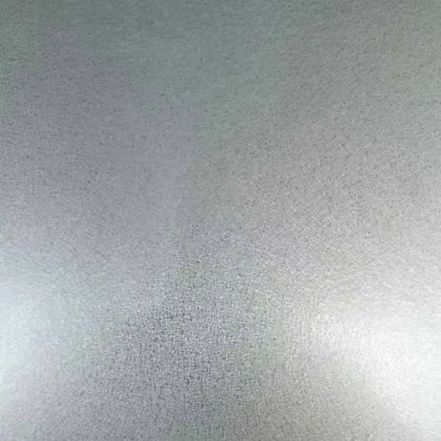 Close-up of matte silver coated steel sheet surface