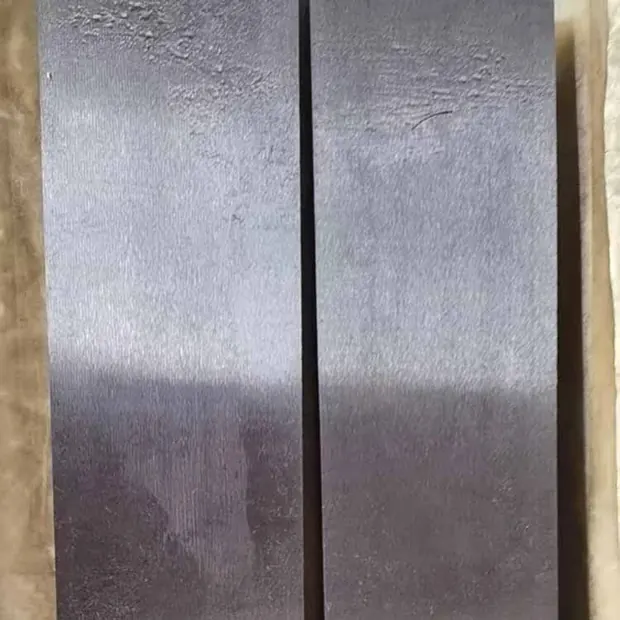 Close-up of gray steel block face with dark vertical groove